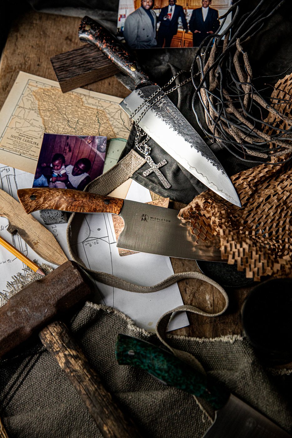 Handmade chef knives with family photographs, maps, and heritage objects